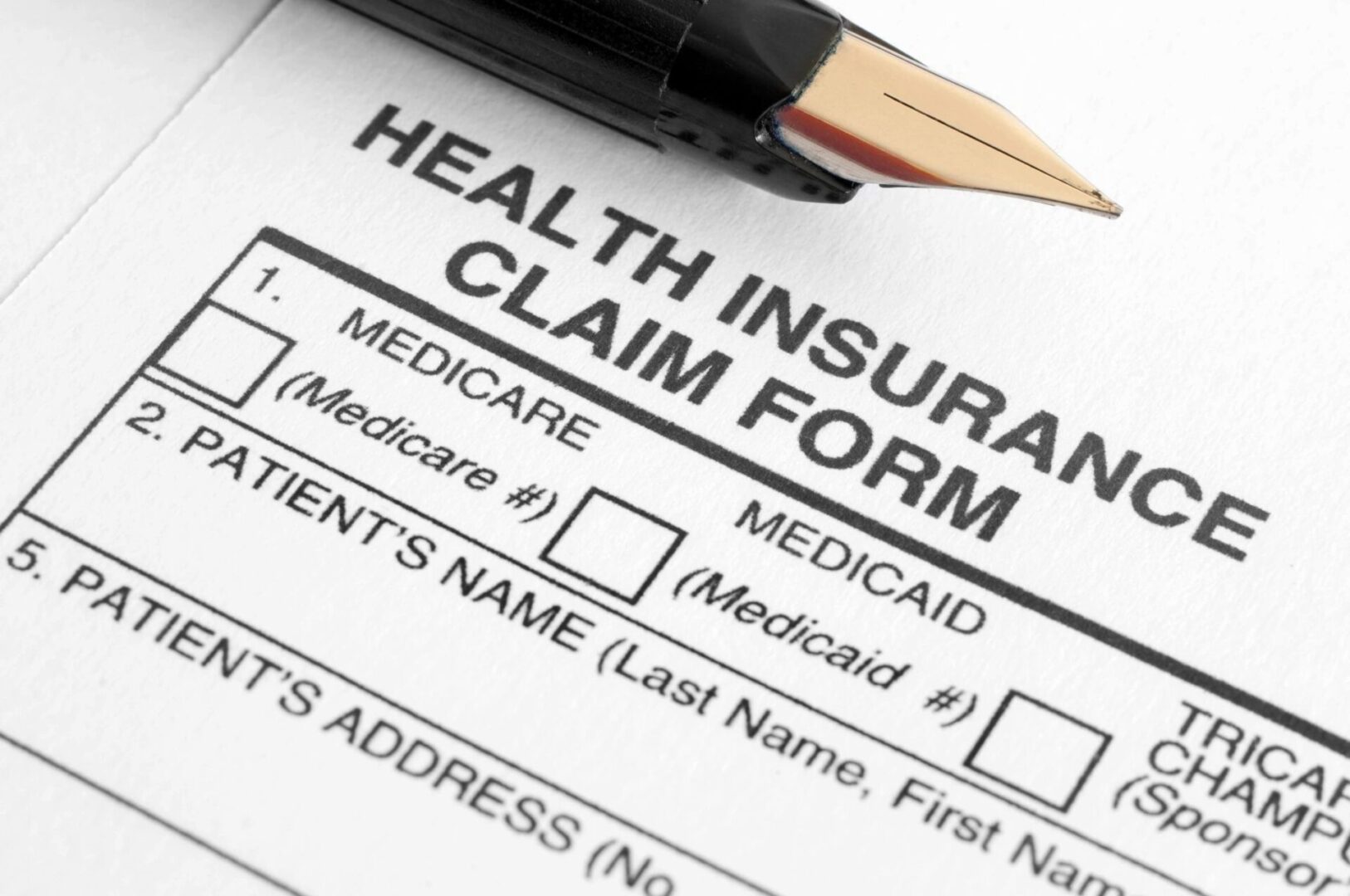 Blank Insurance Claim Form on a Desktop With Pen